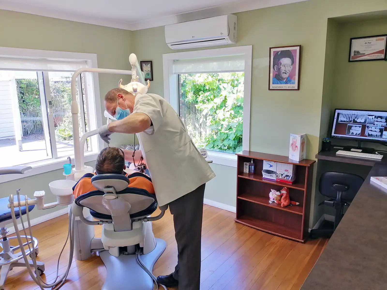 Dr Tony Fox Giving Treatment to Patient on A-dec Dental Chair